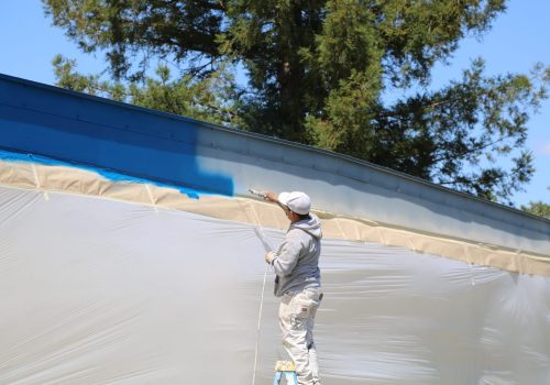 Trim being painted blue by Joaquin Painting Crew Member